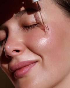Applying hyaluronic acid serum during skin flooding routine